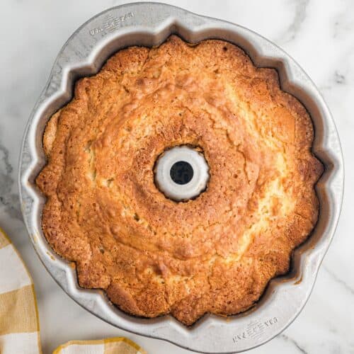 Golden brown Bundt cake in a fluted metal USA pan.