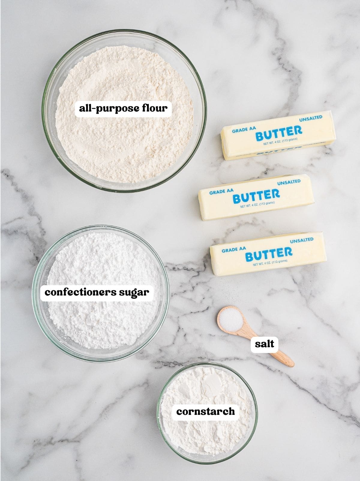 Ingredients for whipped shortbread cookies in labeled bowls and packages.