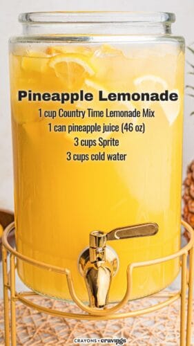 A large glass drink dispenser on a gold stand is filled with pale yellow pineapple lemonade, ice, and lemon slices. Text on the image reads: “Pineapple Lemonade. 1 cup Country Time Lemonade Mix. 1 can pineapple juice (46 oz). 3 cups Sprite. 3 cups cold water.”