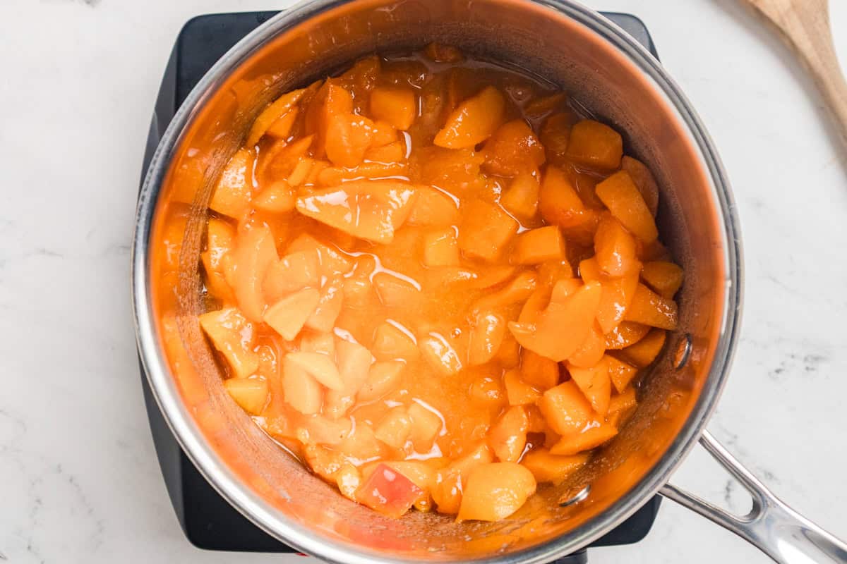 Apricot jam cooking in a saucepan.