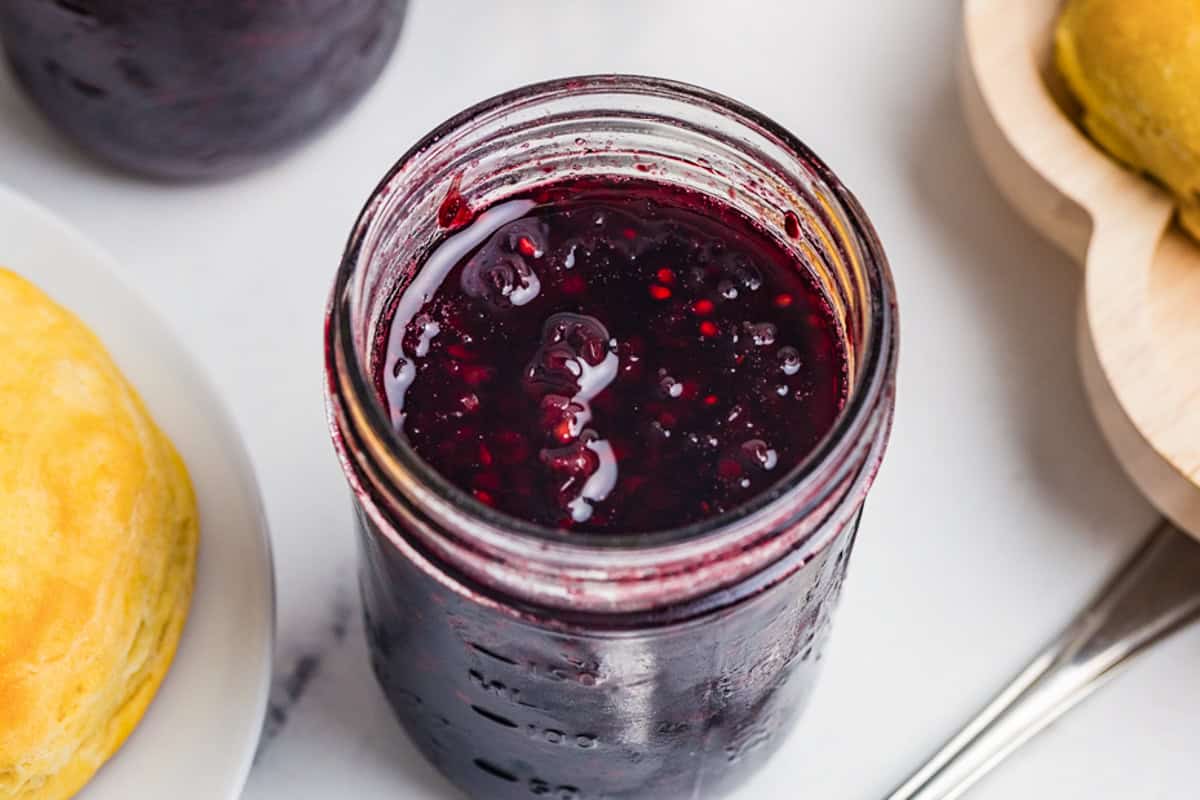 Homemade blackberry jam in a glass mason jar.
