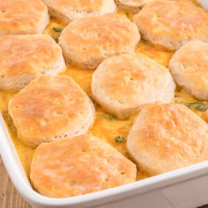 Easy chicken pot pie casserole with biscuits and cheese.